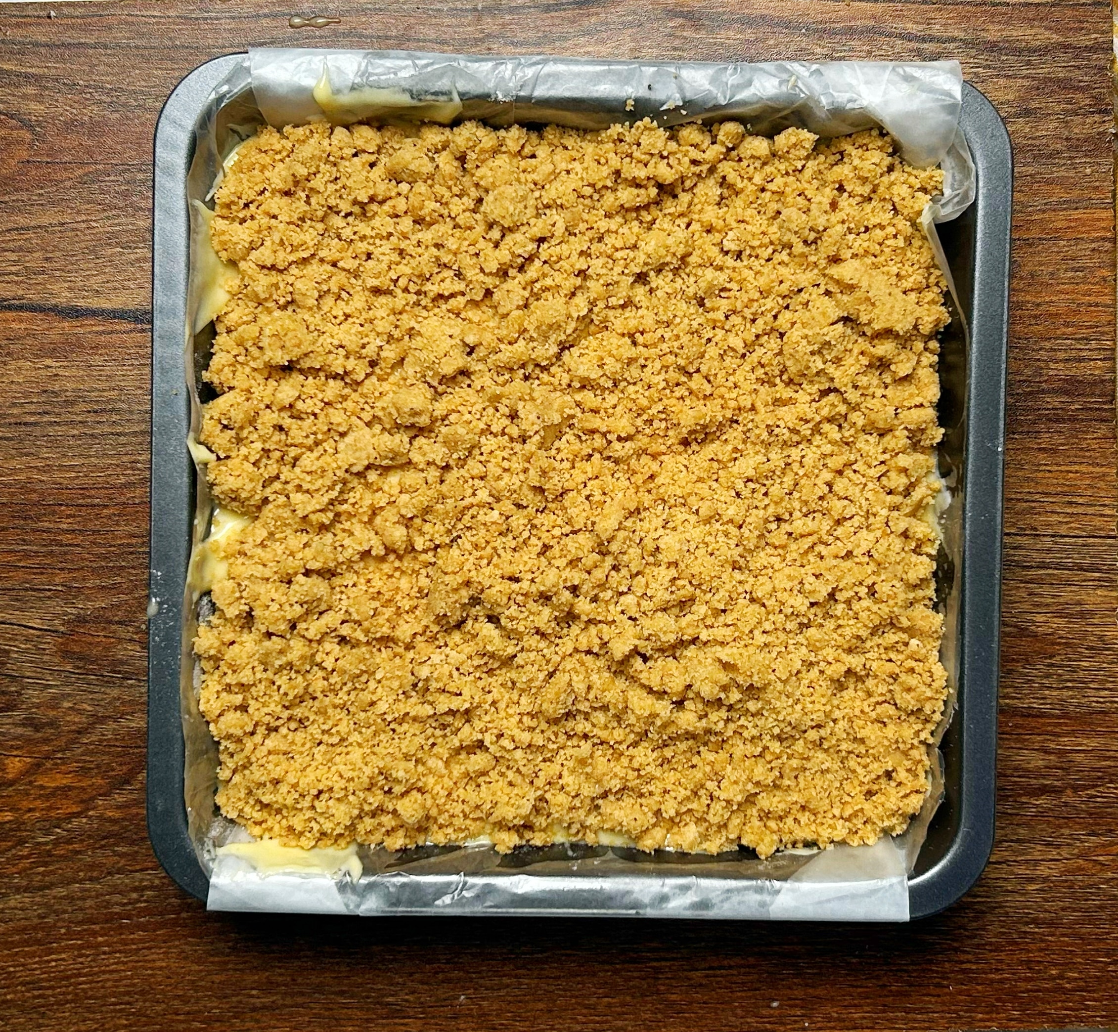 sprinkling streusel on cake 