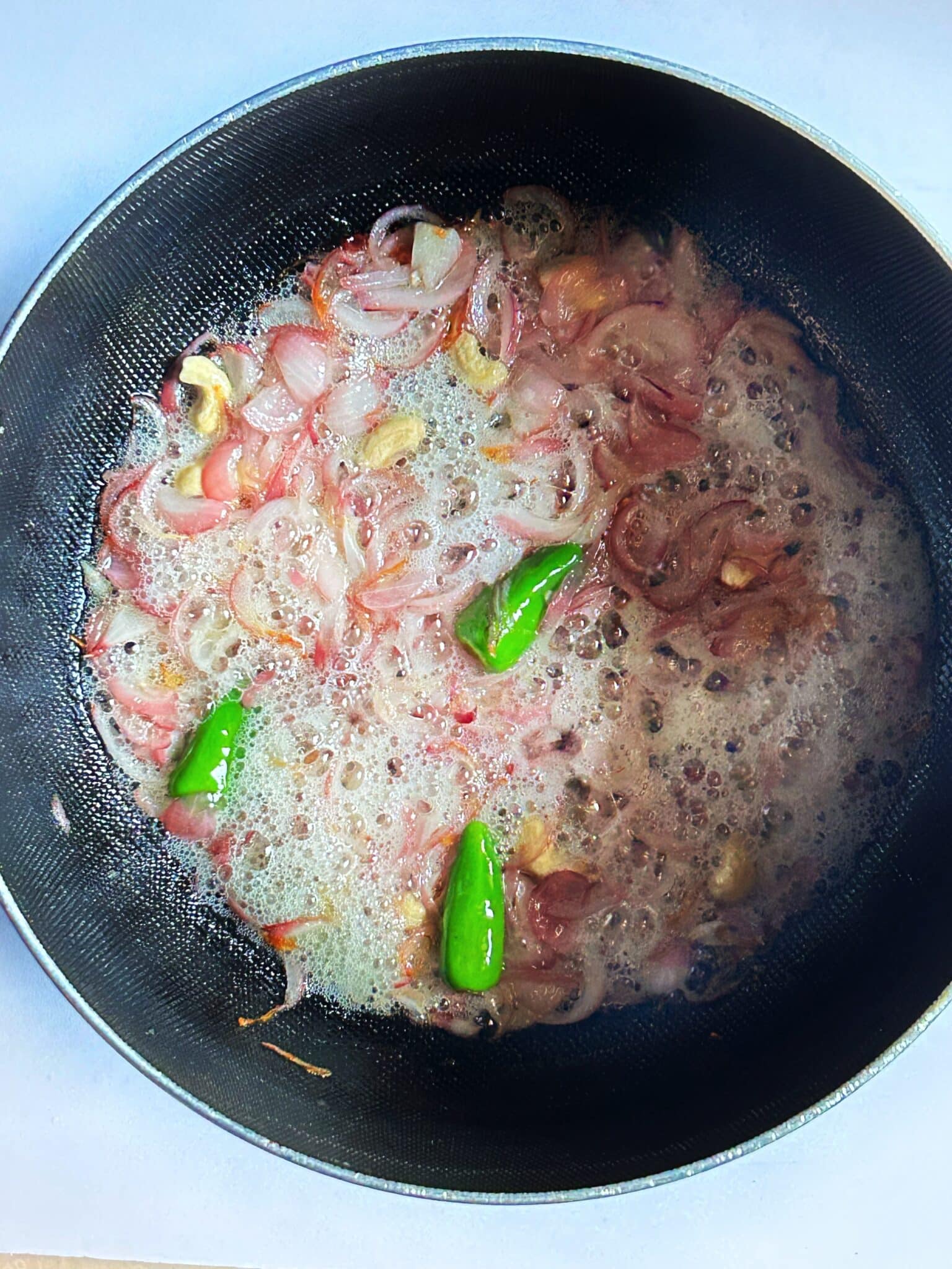frying onion with green chillies frying onion with green chillies