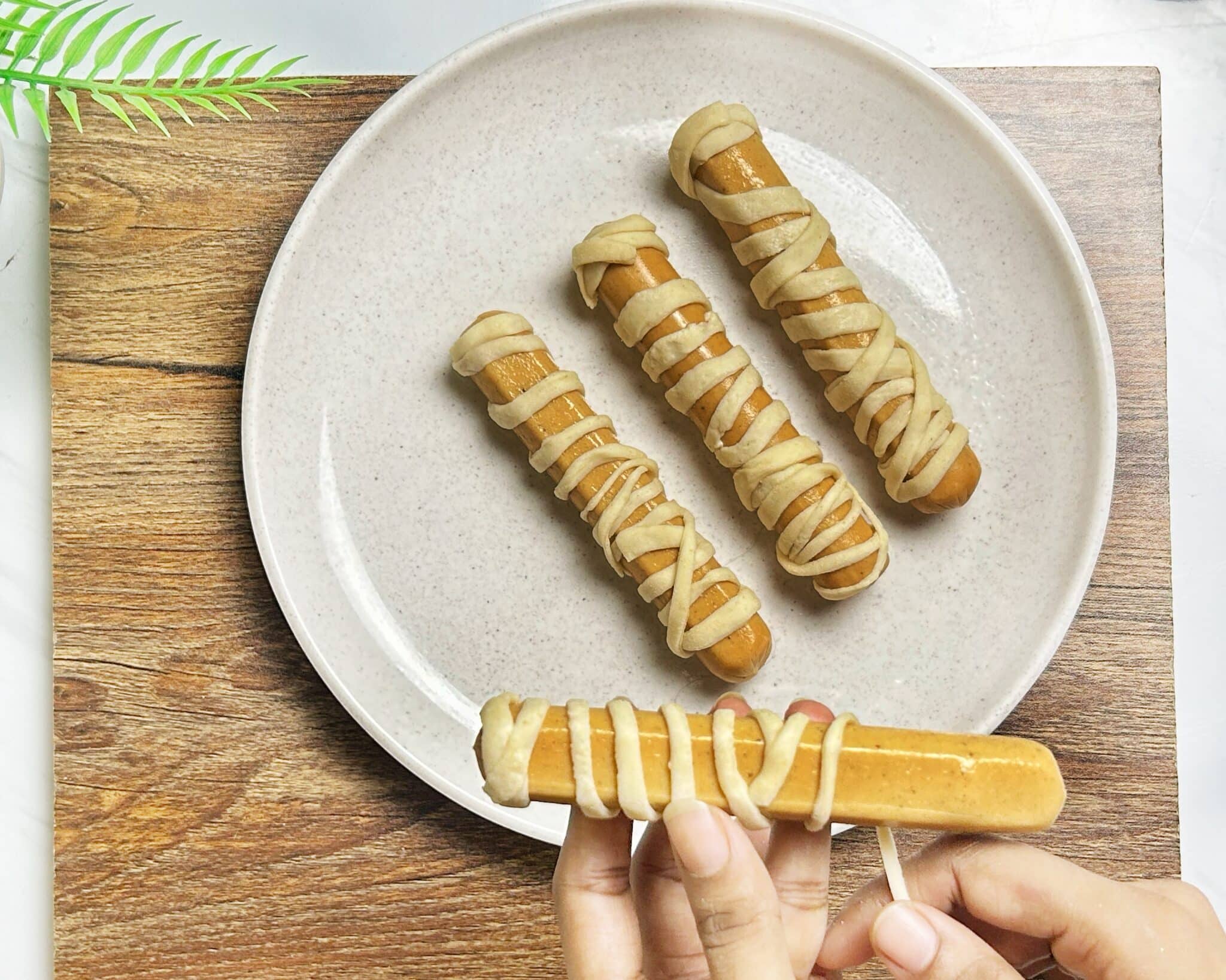 wrapping dough around hot dogs wrapping dough around hot dogs