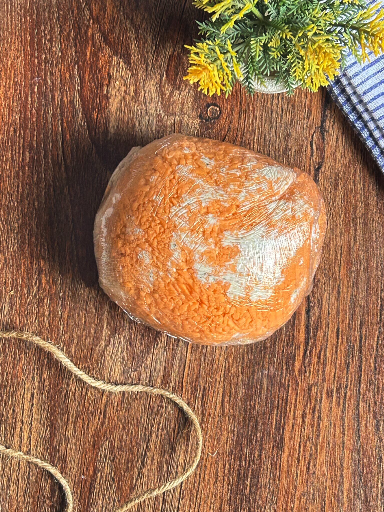 Cheese mixture shaped into a ball and wrapped in plastic Cheese mixture shaped into a ball and wrapped in plastic