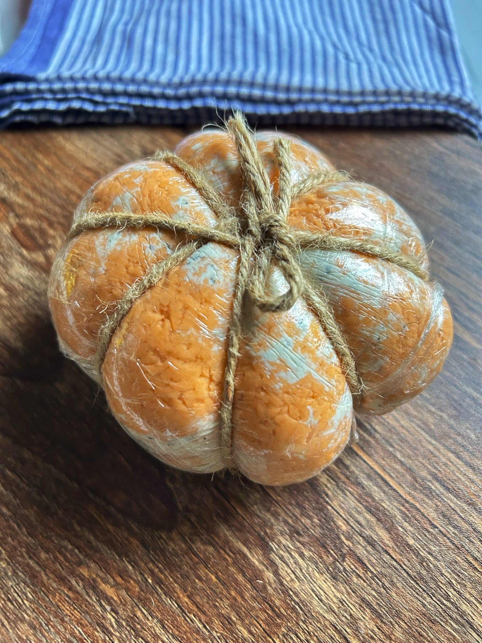 Wrapped cheese ball shaped like a pumpkin and chilled Wrapped cheese ball shaped like a pumpkin and chilled