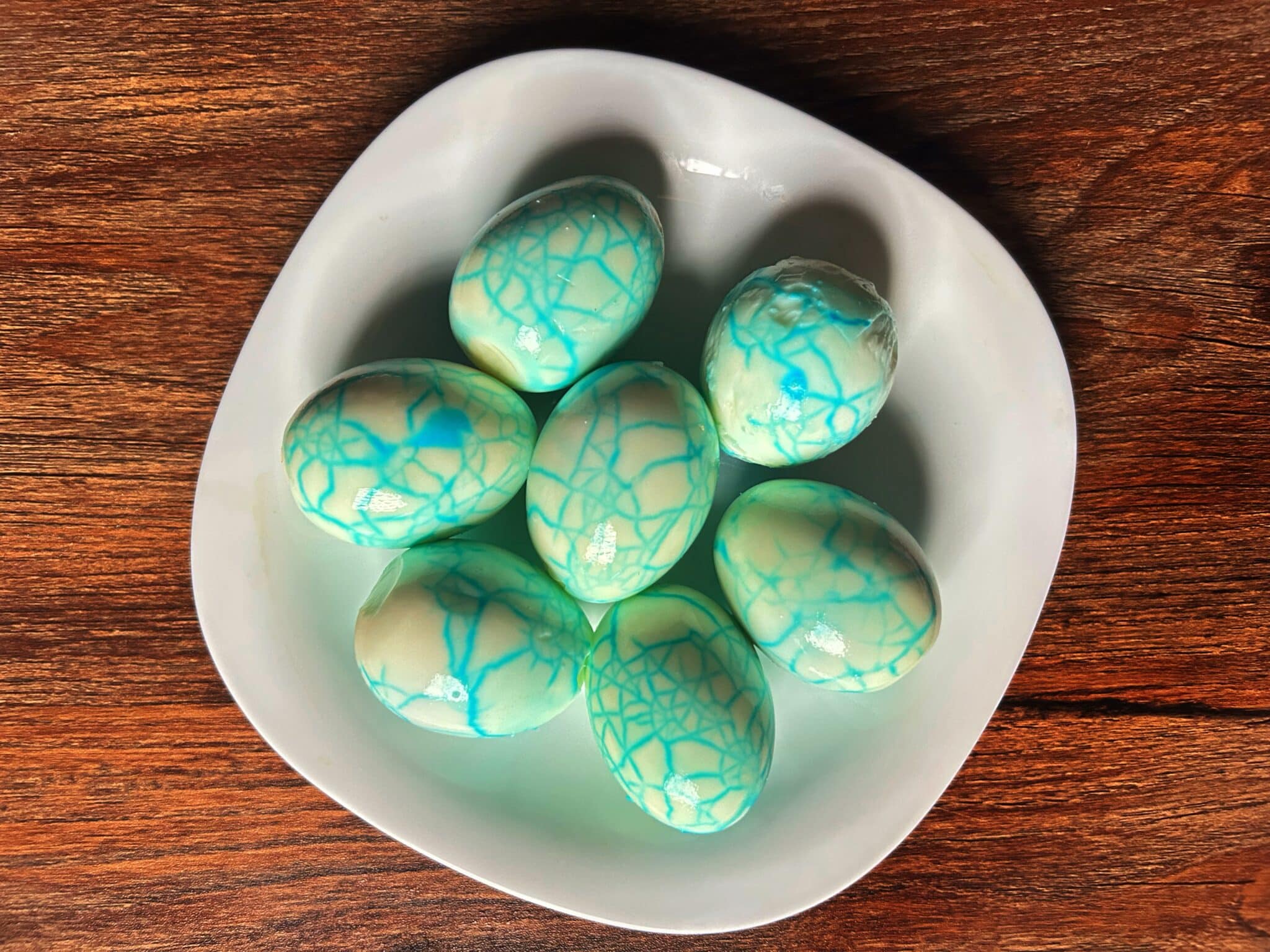 Peeled eggs showing a blue marbled pattern Peeled eggs showing a blue marbled pattern