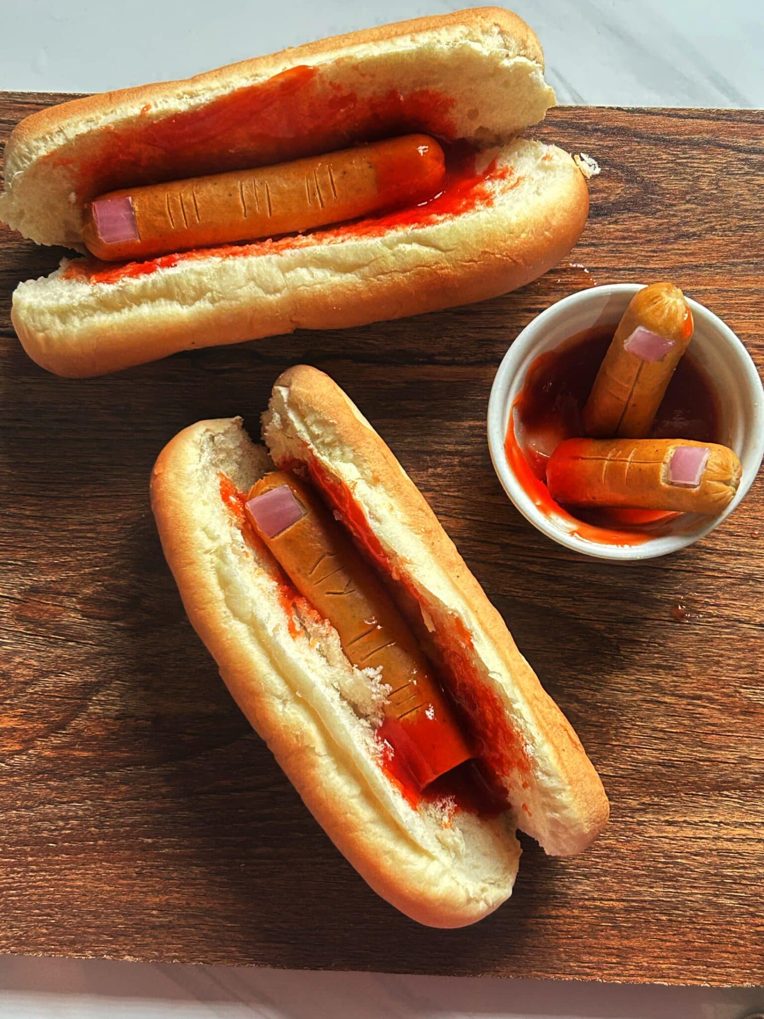 Plated hot dog fingers with ketchup, ready to serve for Halloween Plated hot dog fingers with ketchup, ready to serve for Halloween