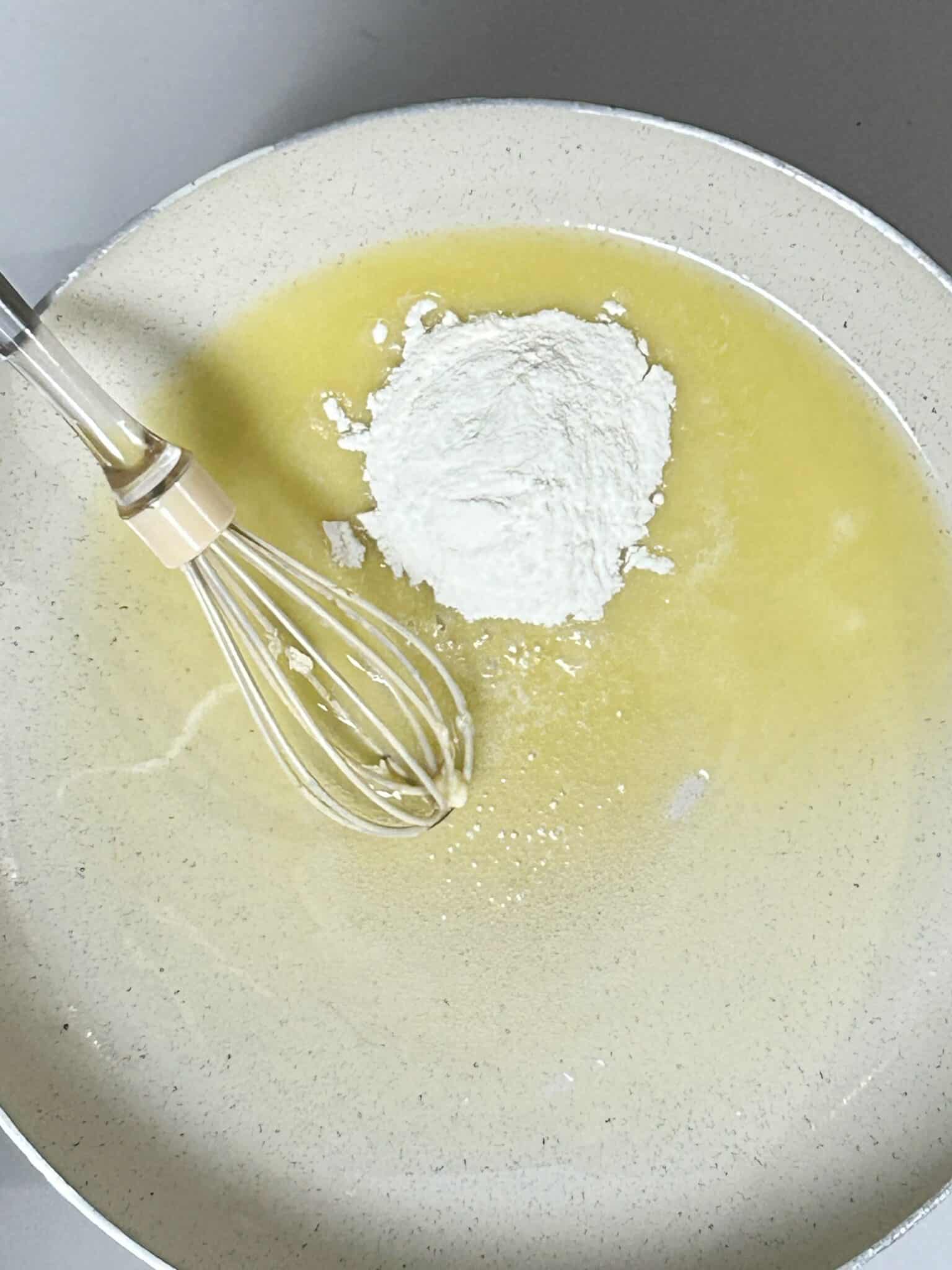Melted butter and flour being stirred into a smooth roux in a saucepan Melted butter and flour being stirred into a smooth roux in a saucepan