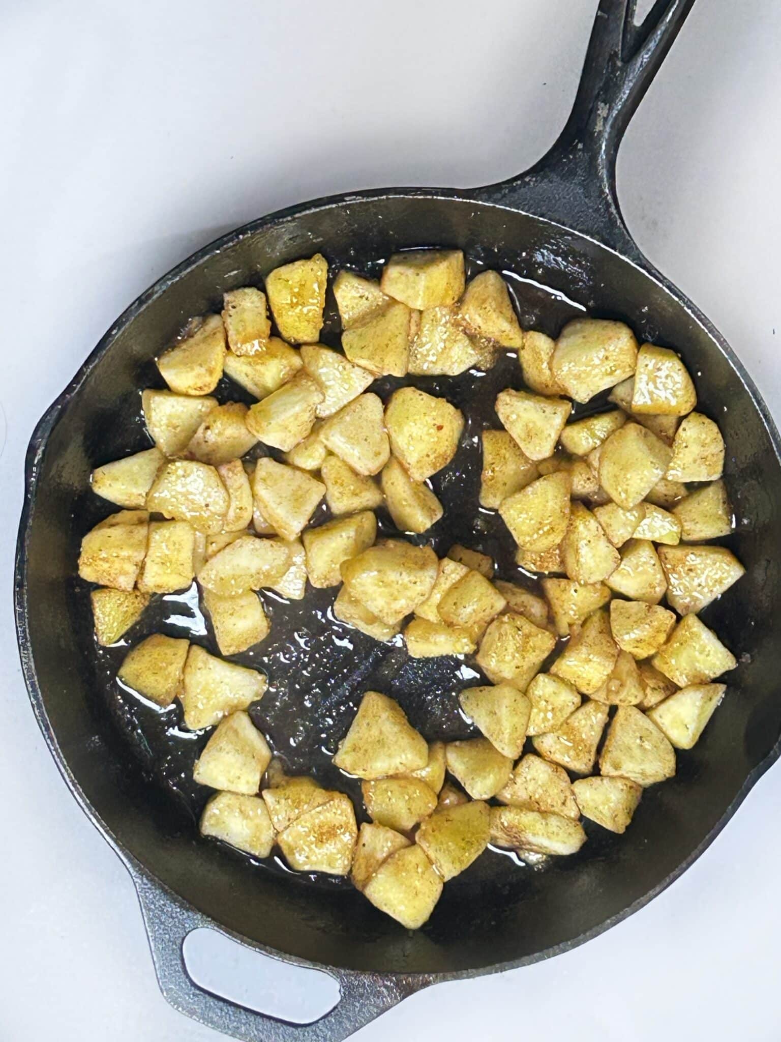 Cooking chopped apples with butter in a skillet Cooking chopped apples with butter in a skillet