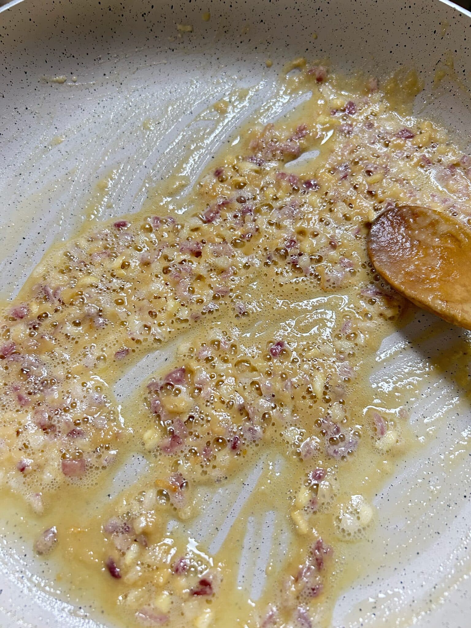 Roux being stirred in a pan until it turns a golden color Roux being stirred in a pan until it turns a golden color