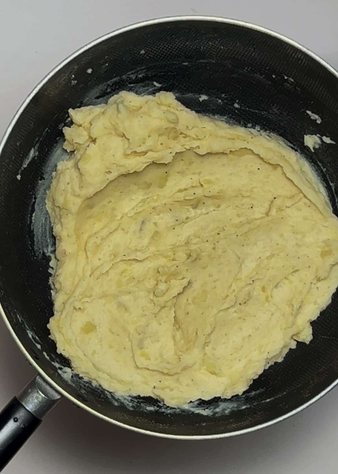 Topping mashed potatoes with melted butter and parsley Topping mashed potatoes with melted butter and parsley