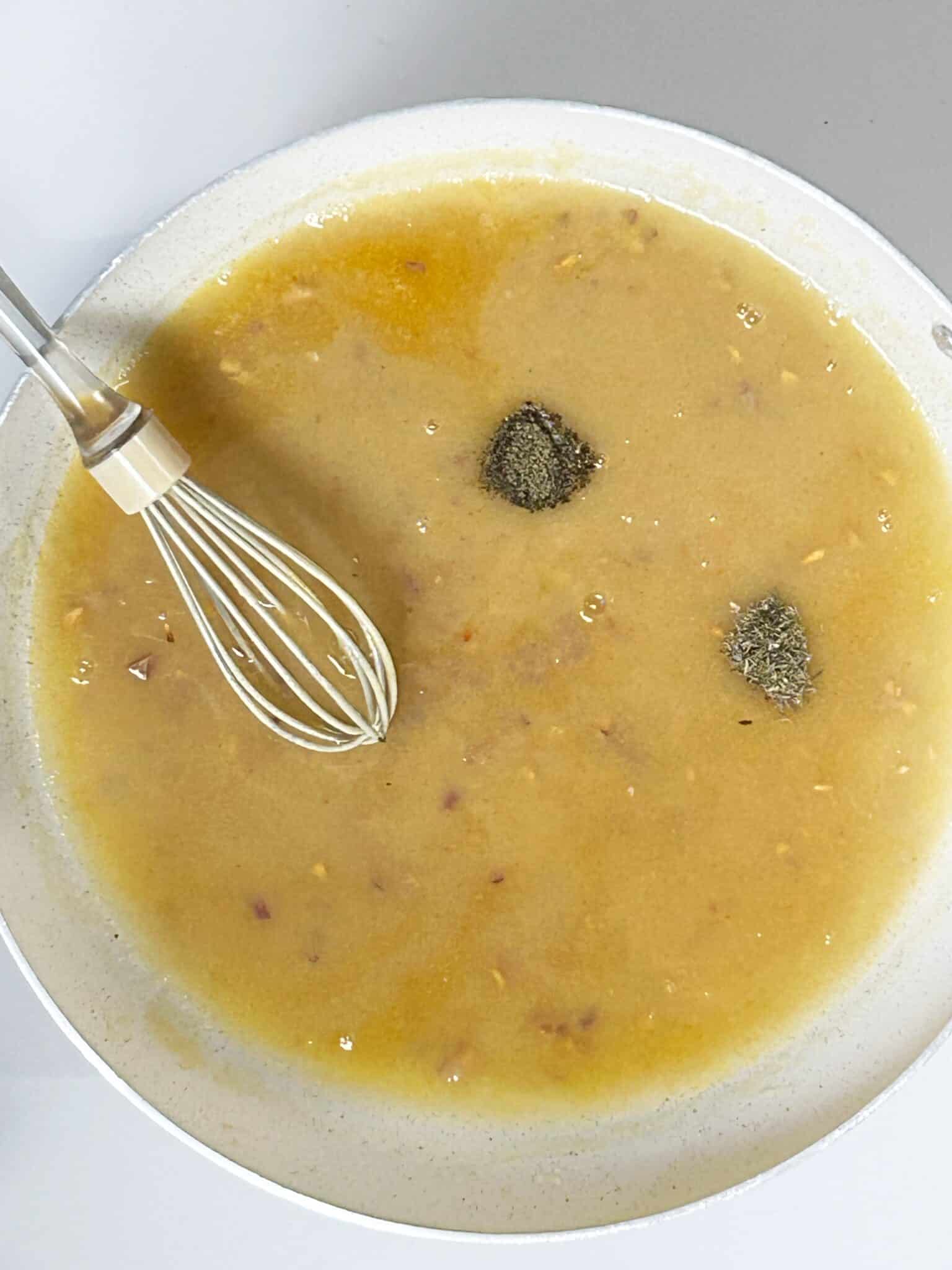 Gravy being stirred as it thickens in the saucepan Gravy being stirred as it thickens in the saucepan