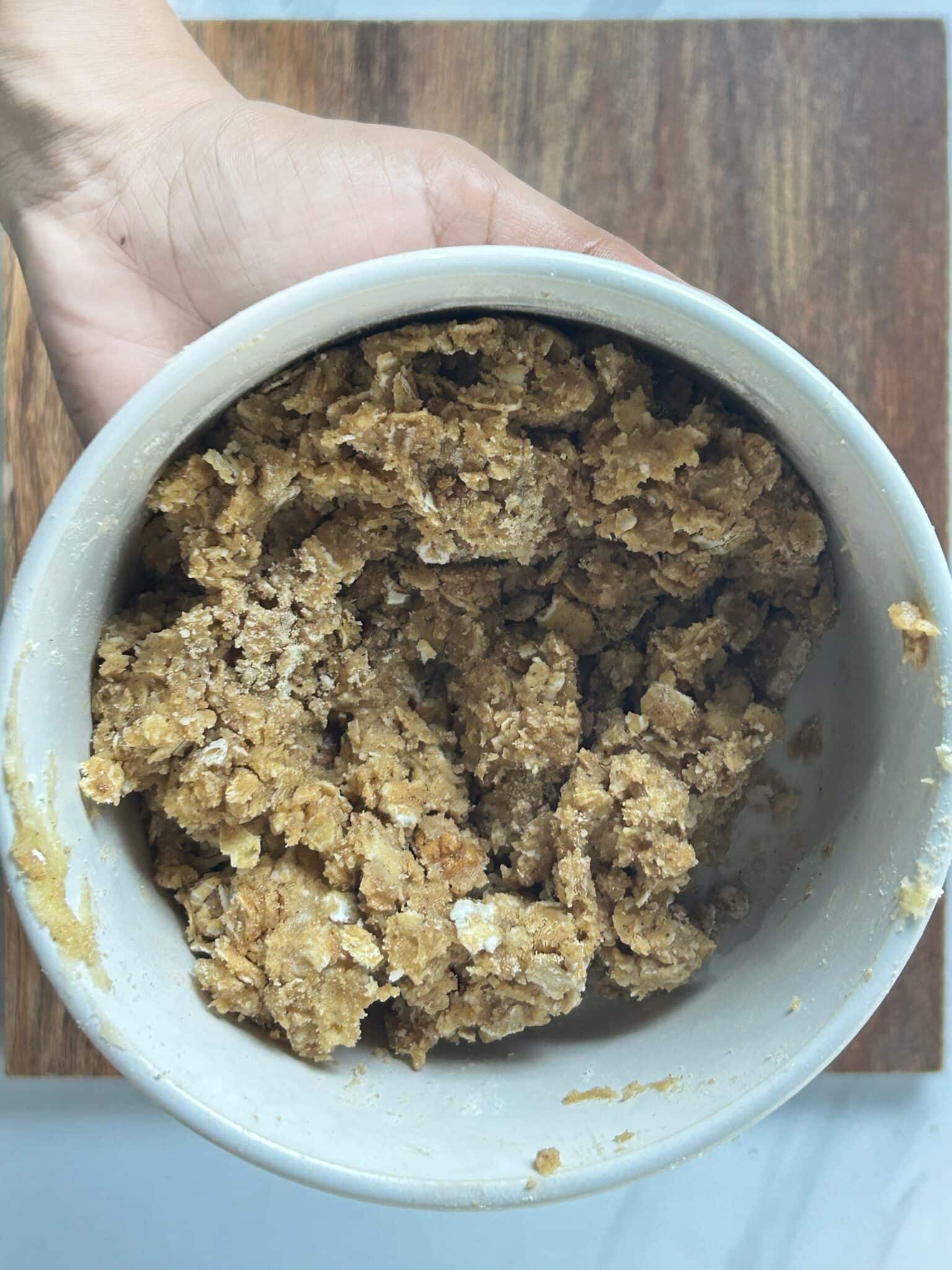 Mixing ingredients until a crumbly topping forms Mixing ingredients until a crumbly topping forms