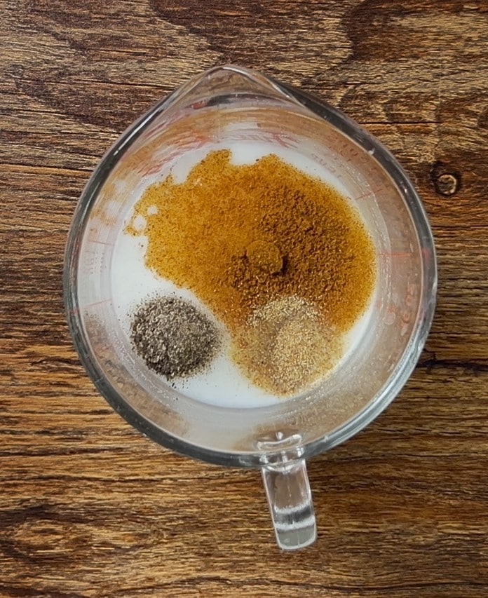 Buttermilk and spices whisked for chicken finger marinade Buttermilk and spices whisked for chicken finger marinade