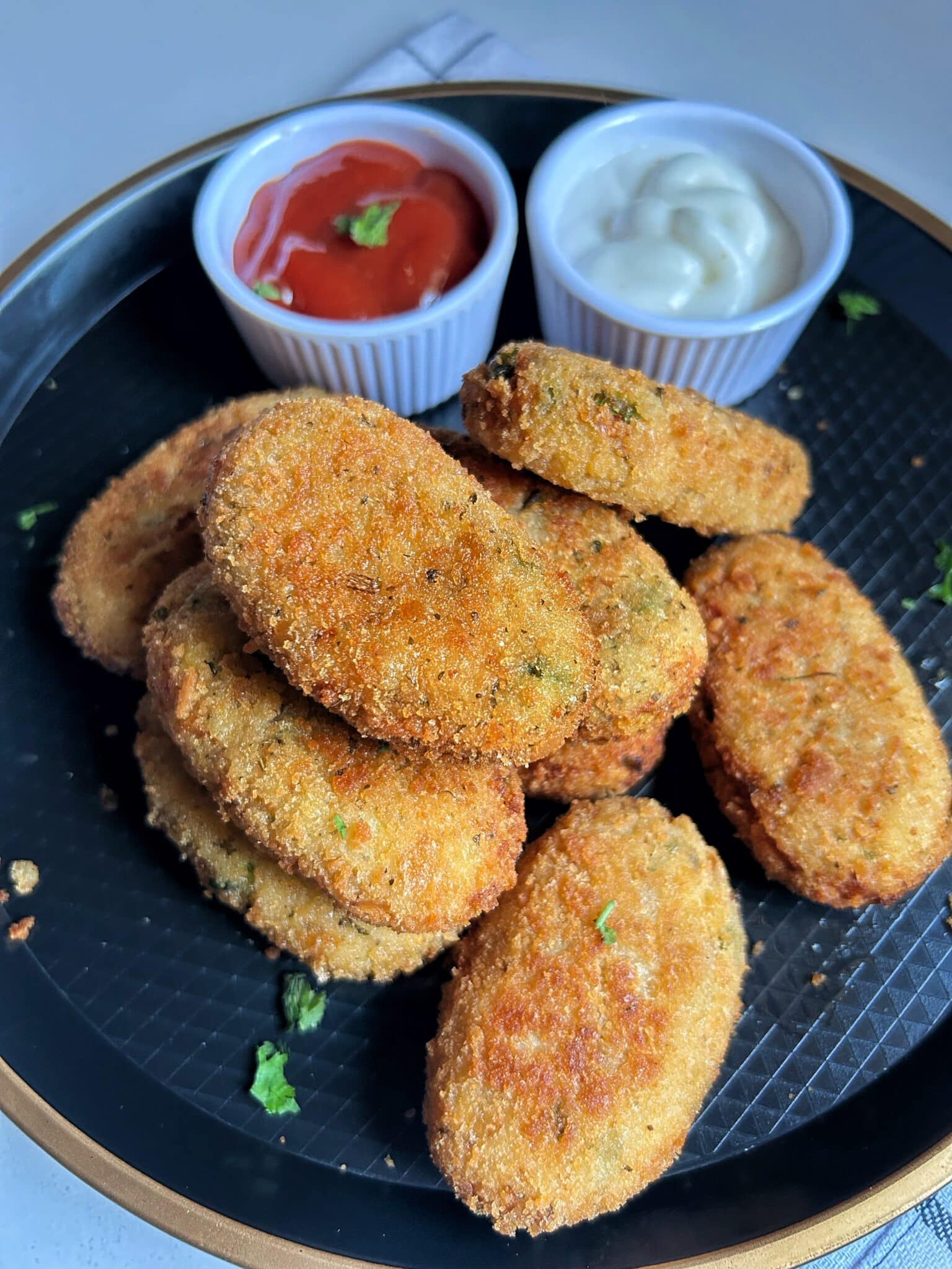 Serving hot chicken and potato croquettes with ketchup and mayonnaise Serving hot chicken and potato croquettes with ketchup and mayonnaise
