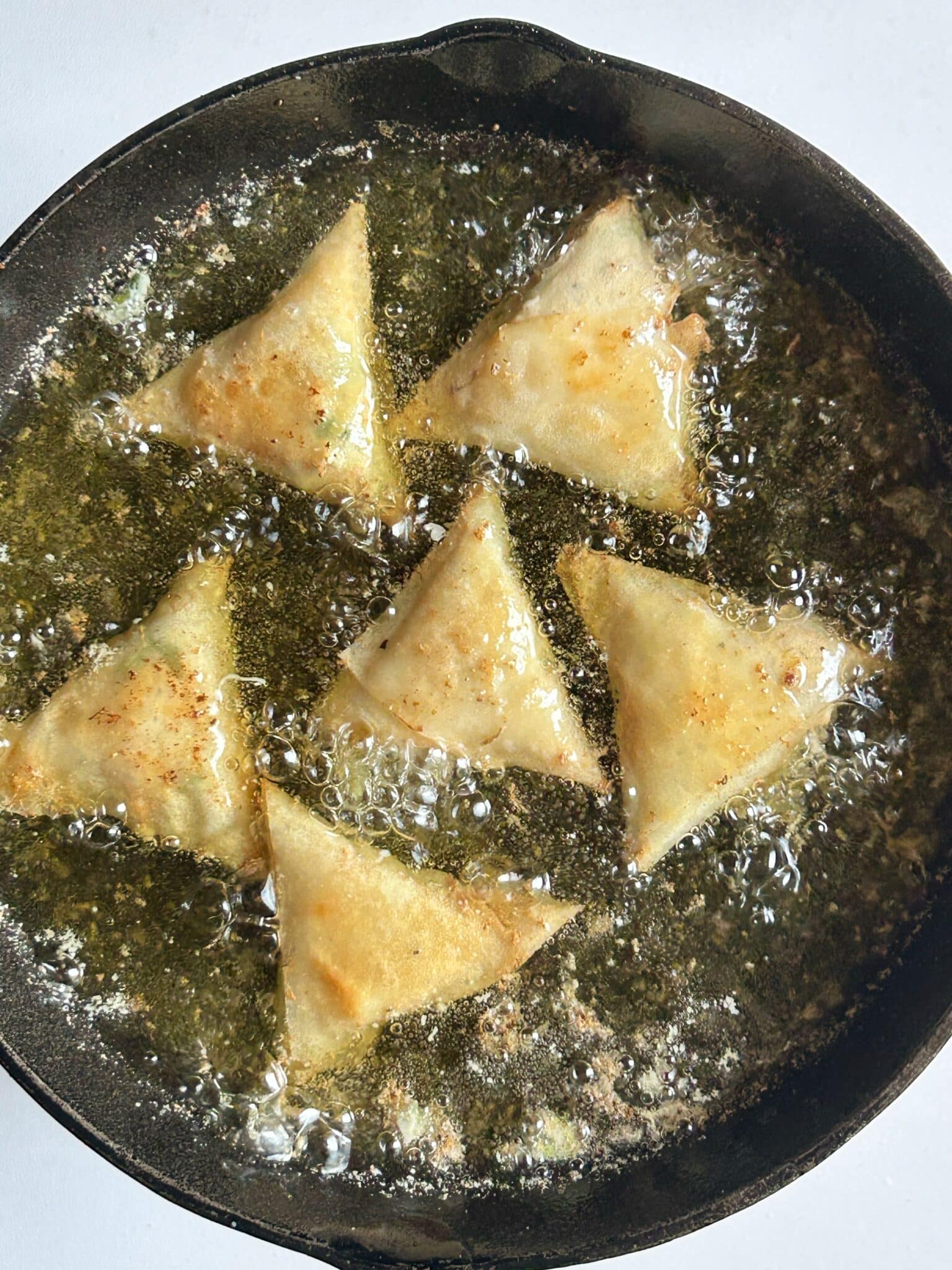 Deep frying Chicken Malai Boti Samosa until golden brown Deep frying Chicken Malai Boti Samosa until golden brown