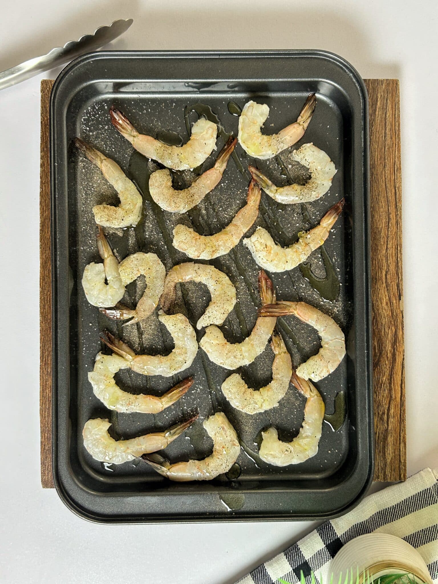Seasoned shrimp on sheet pan ready to roast Seasoned shrimp on sheet pan ready to roast