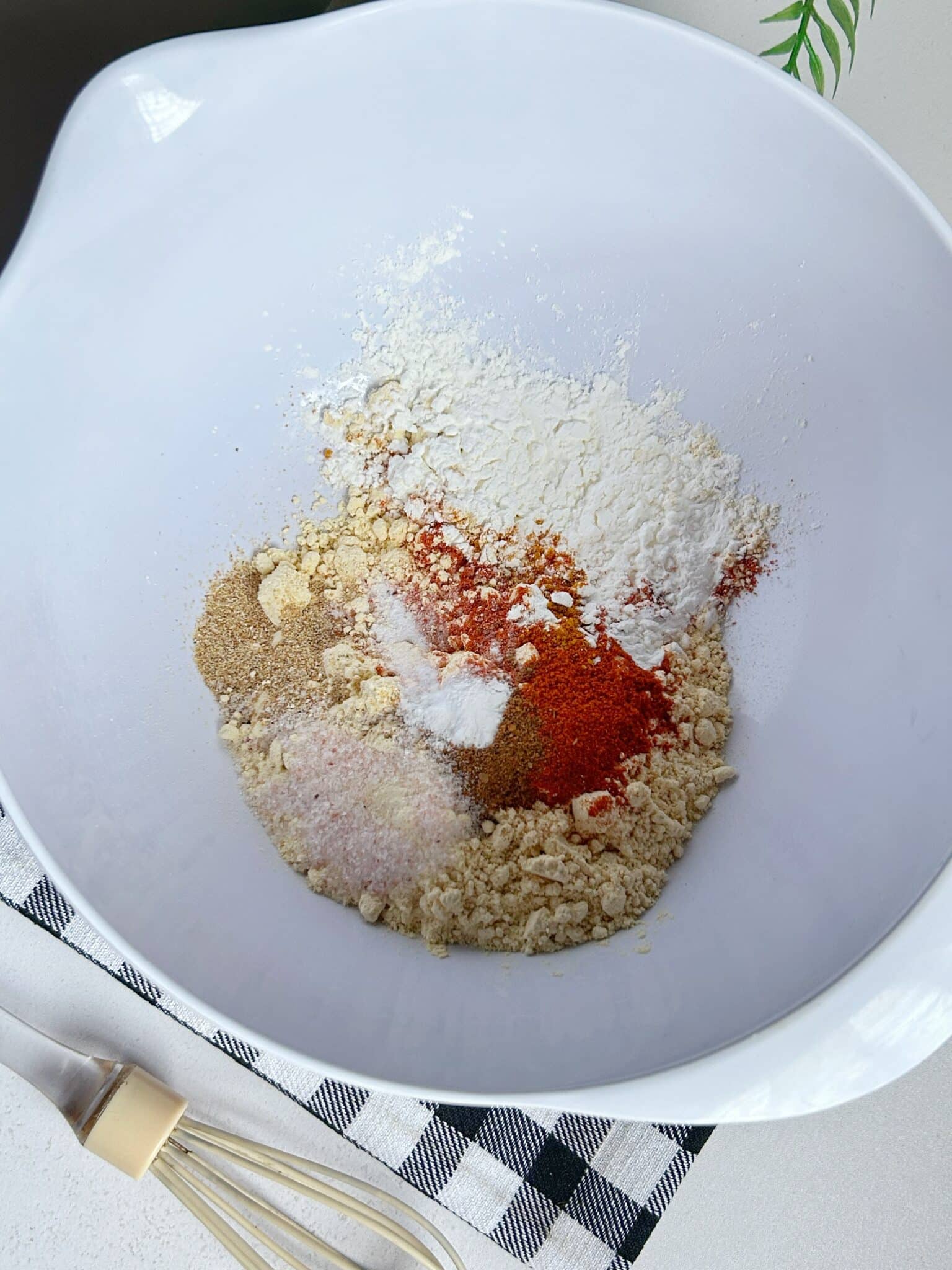 Mixing spices and gram flour for chicken pakora batter Mixing spices and gram flour for chicken pakora batter