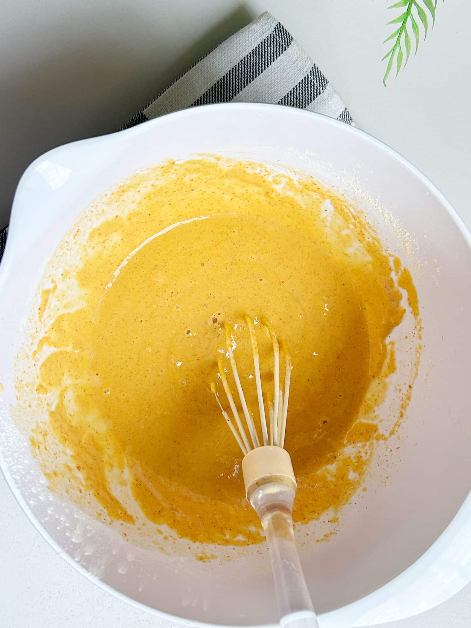 Adding water and coriander to make chicken pakora batter and letting it rest. Adding water and coriander to make chicken pakora batter and letting it rest.