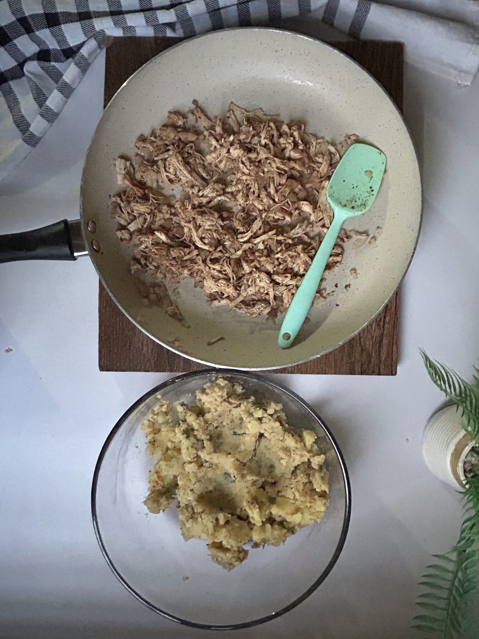 Chicken mixture combined with seasoned mashed potatoes in a bowl Chicken mixture combined with seasoned mashed potatoes in a bowl