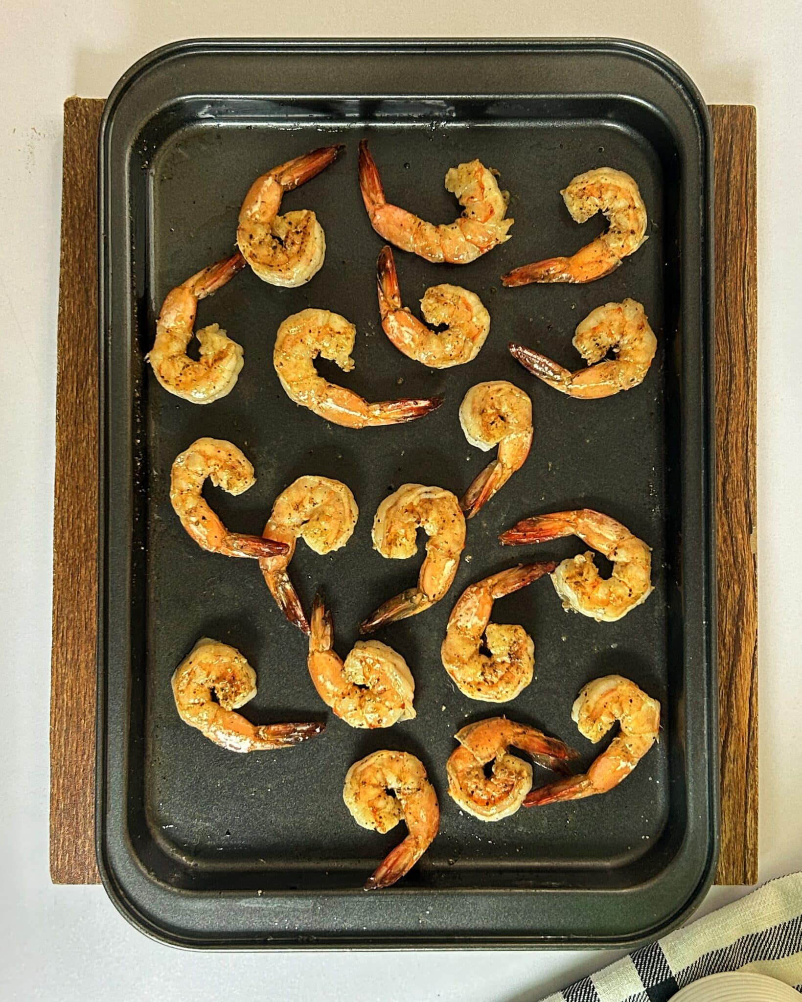 Shrimp roasting in the oven until pink and fully cooked Shrimp roasting in the oven until pink and fully cooked