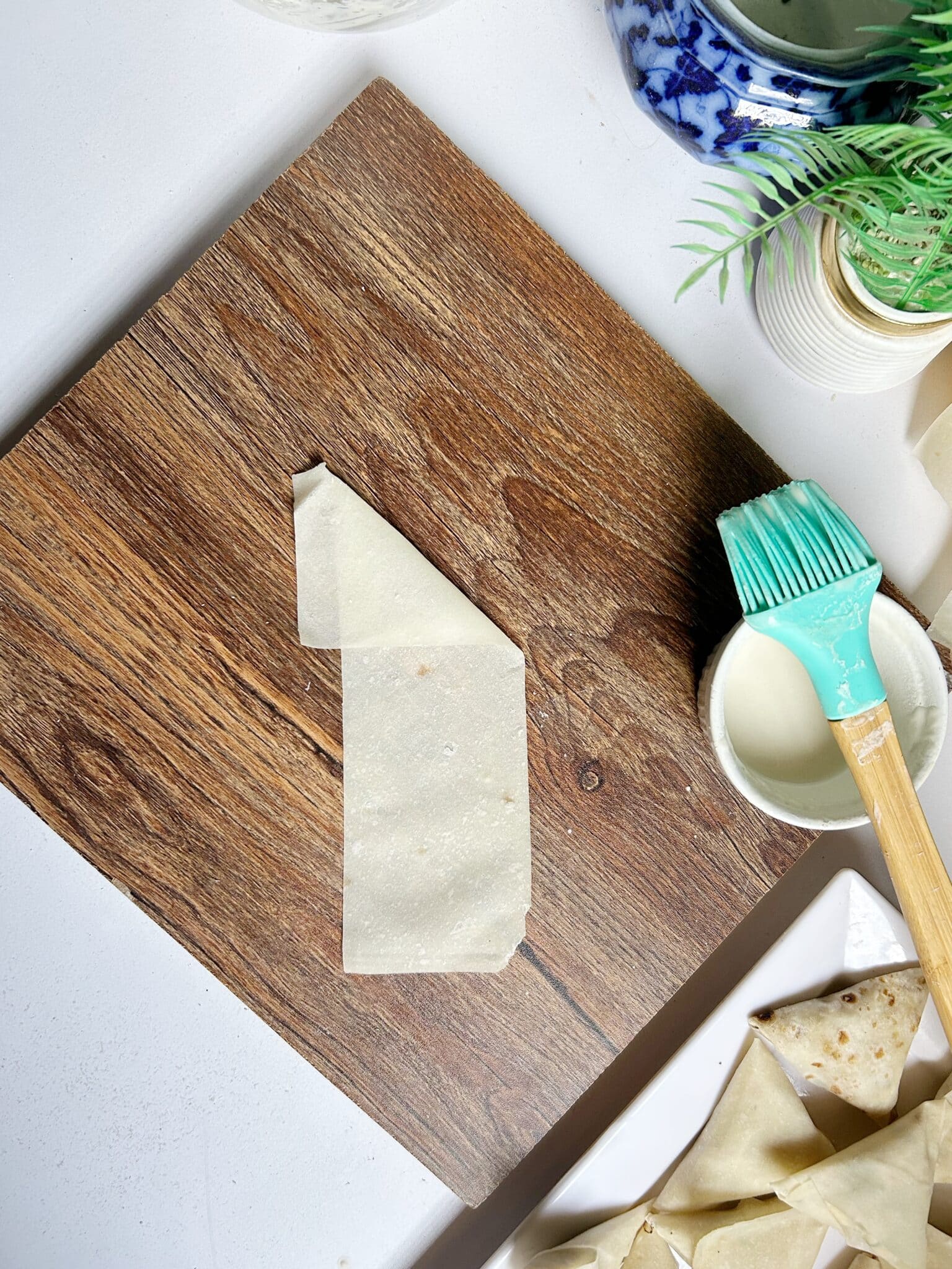 Folding samosa patti sheets with Chicken Malai Boti filling Folding samosa patti sheets with Chicken Malai Boti filling