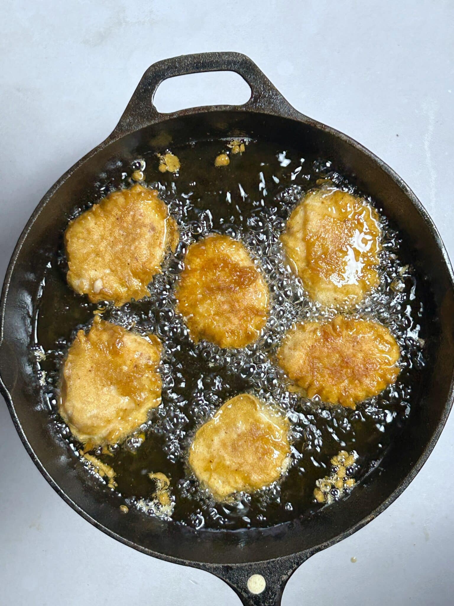 Cooking battered chicken nuggets in hot oil for a crispy golden crust Cooking battered chicken nuggets in hot oil for a crispy golden crust