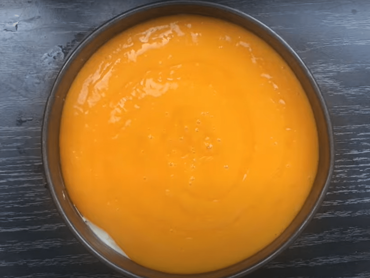 pour the mango puree as third layer on the cake