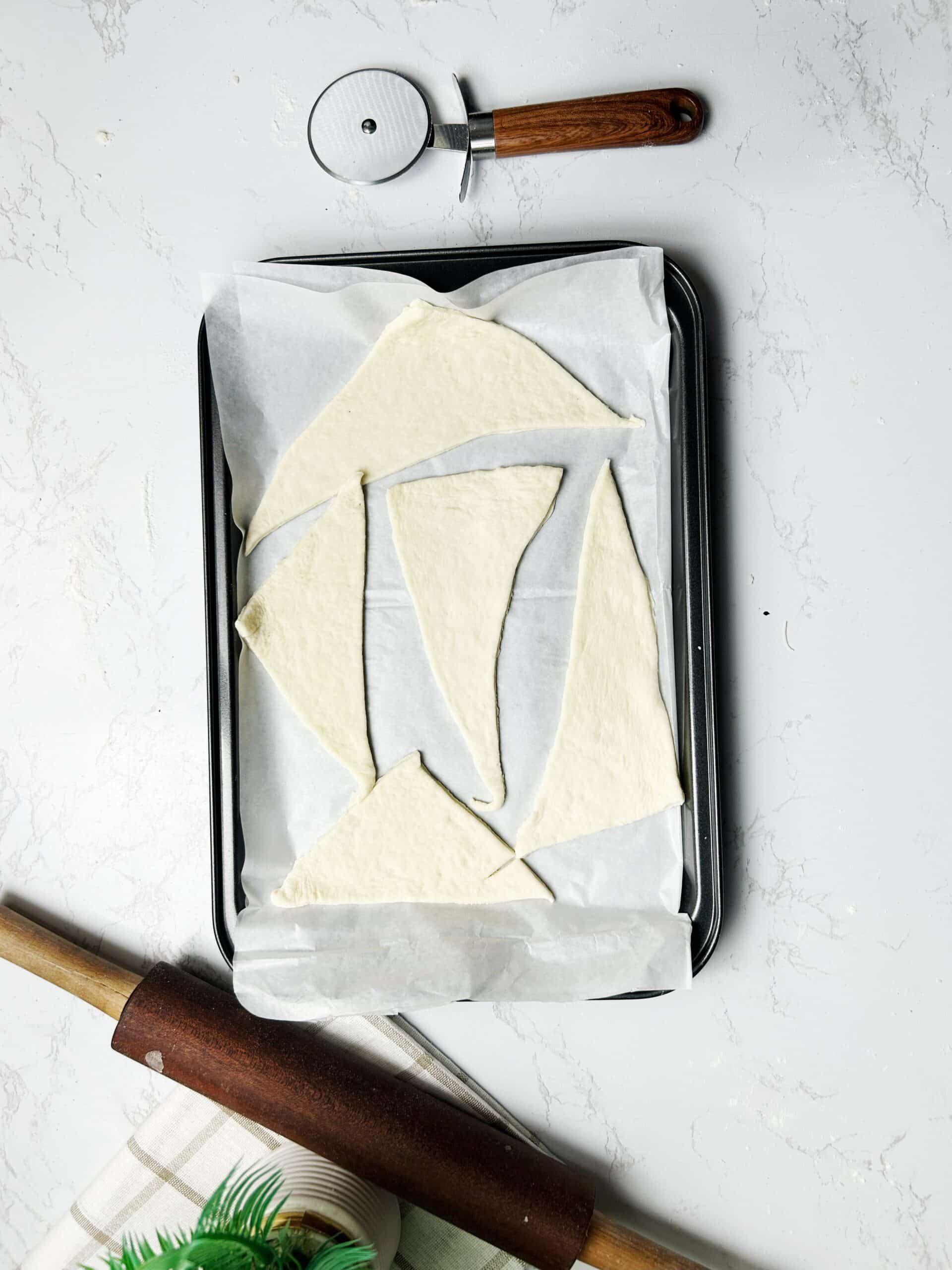 cutting dough into triangle shape