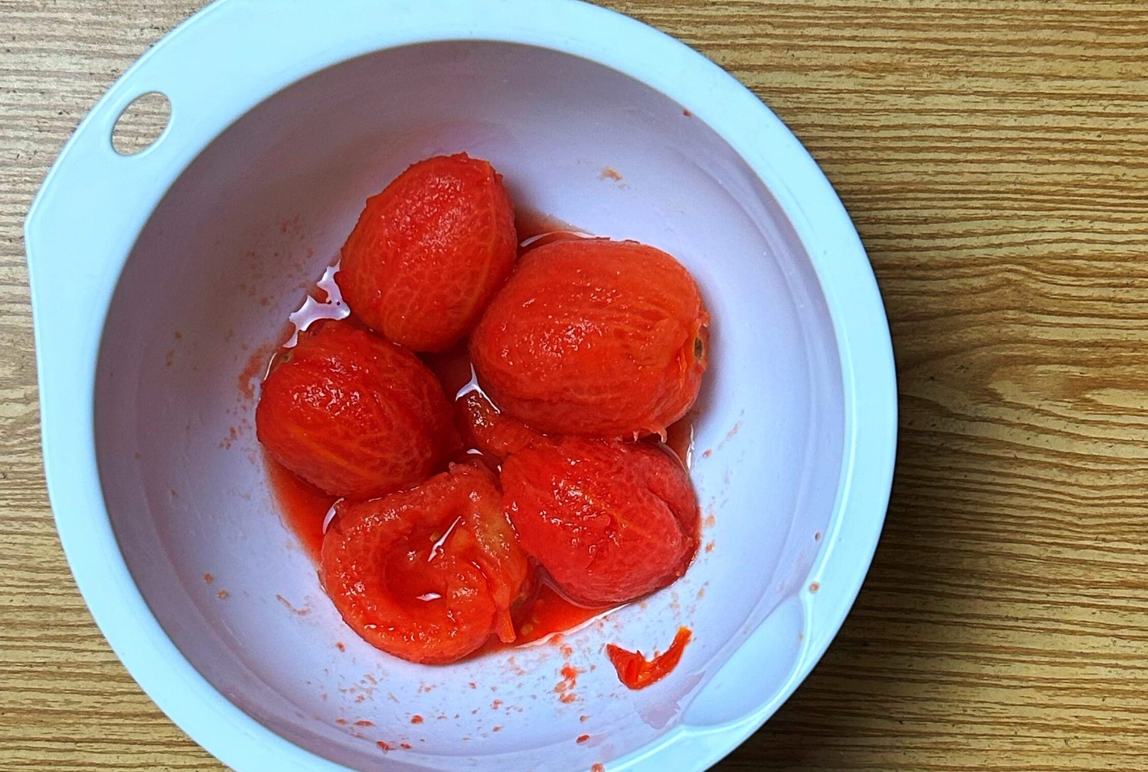 peeled and boiled tomatoes in a bowl