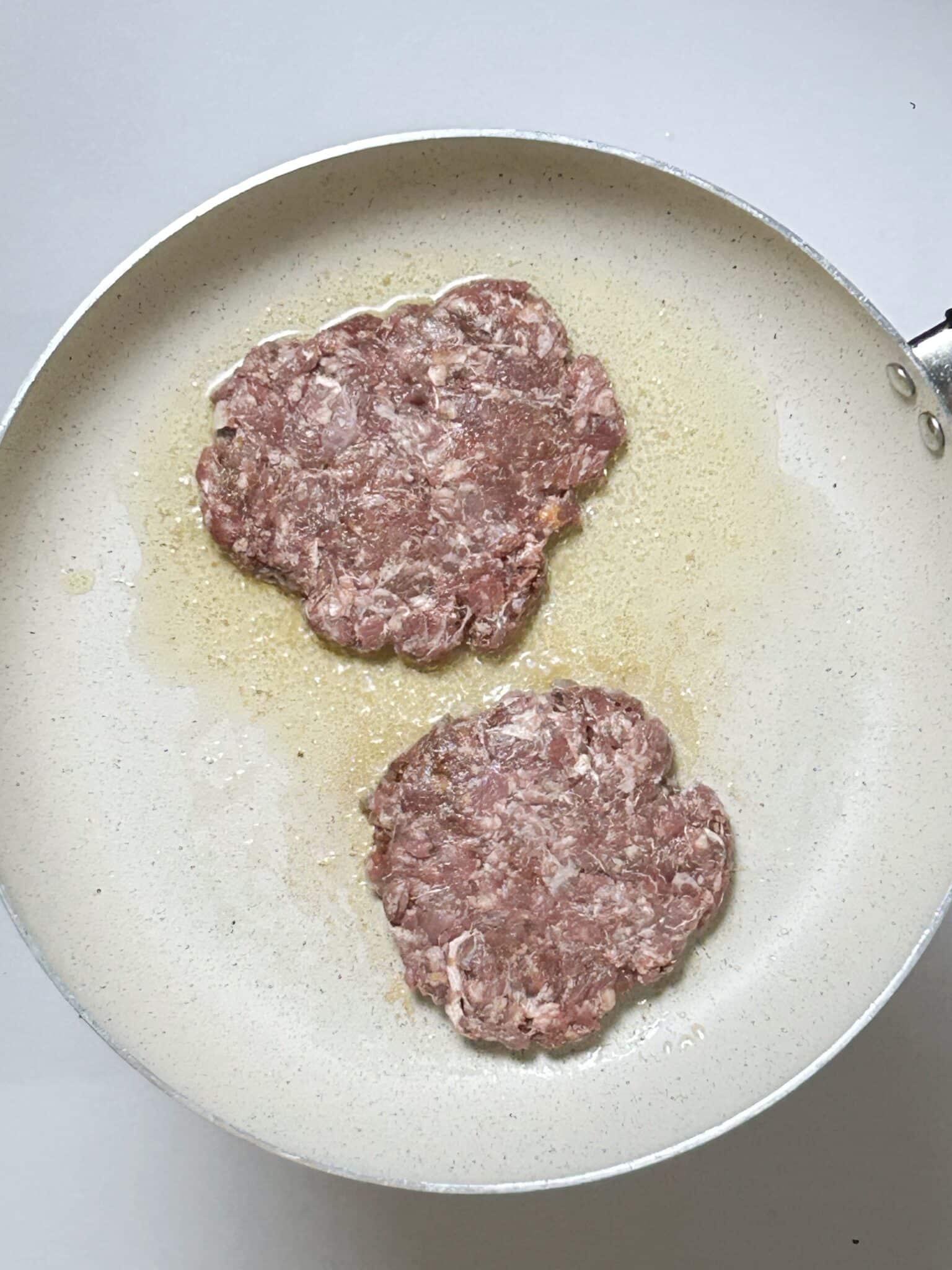 frying burger patties in a skillet