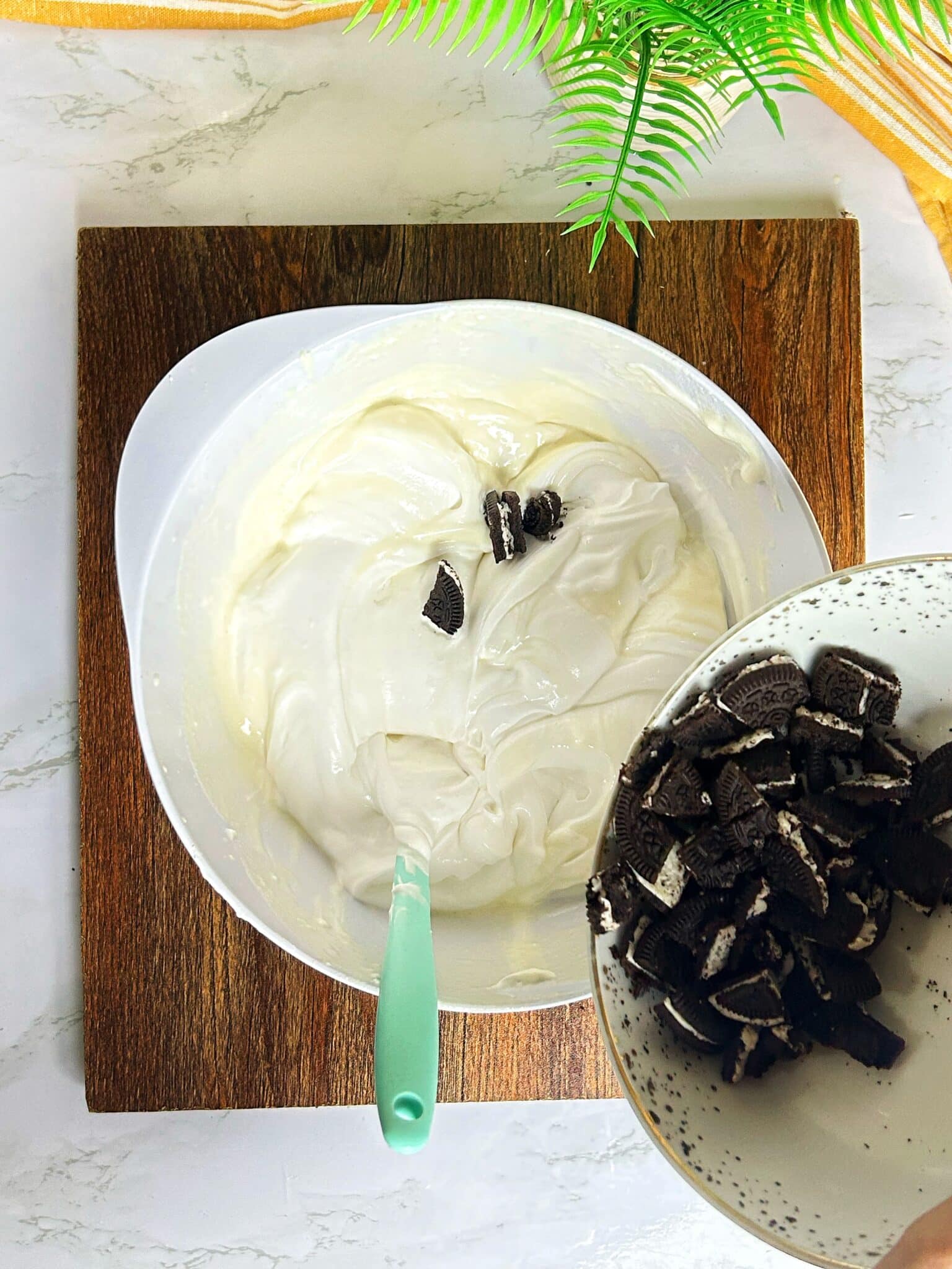 adding crushed oreos to the cream cheese filling